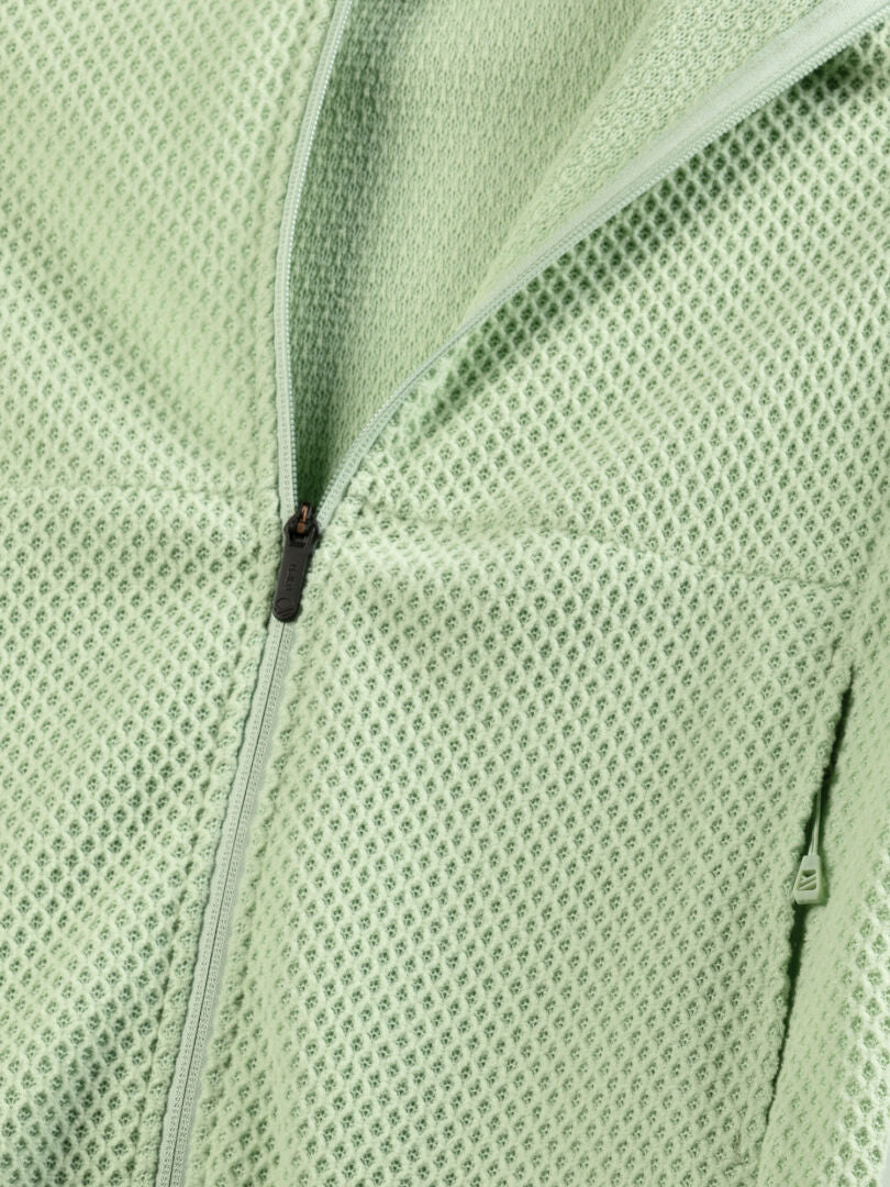Close-up of Halti Ultramove Layer Jacket Womens in light green with mesh fabric and partially open center zipper.