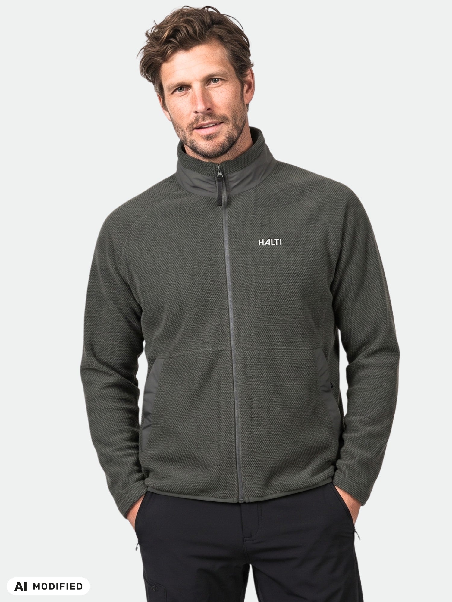 Man wearing a Halti Soolo Layer Jacket, dark gray, with hands in pockets—ideal everyday men's fleece sweatshirt.