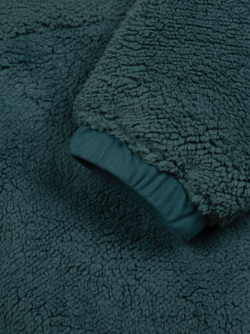 Close-up of Halti Lumista Polar Fleece Jacket Women’s sleeve, showing soft teal fabric and detailed cuff texture.