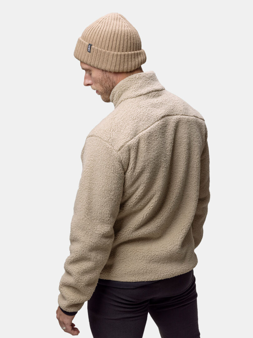 A person in a Lumista Polar Fleece Jacket Mens by Halti faces away, showing the back of their outfit.