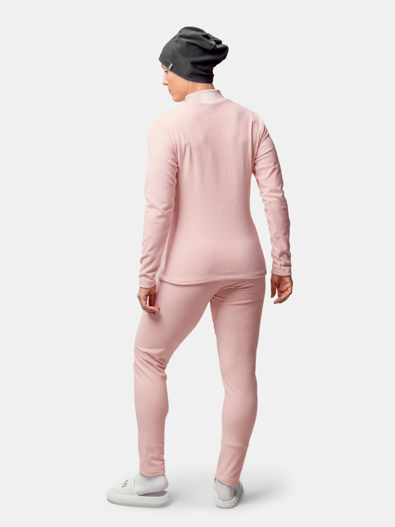 A person wears the Halti Trone Fleece Shirt for women, with matching pants, gray beanie, and white shoes.