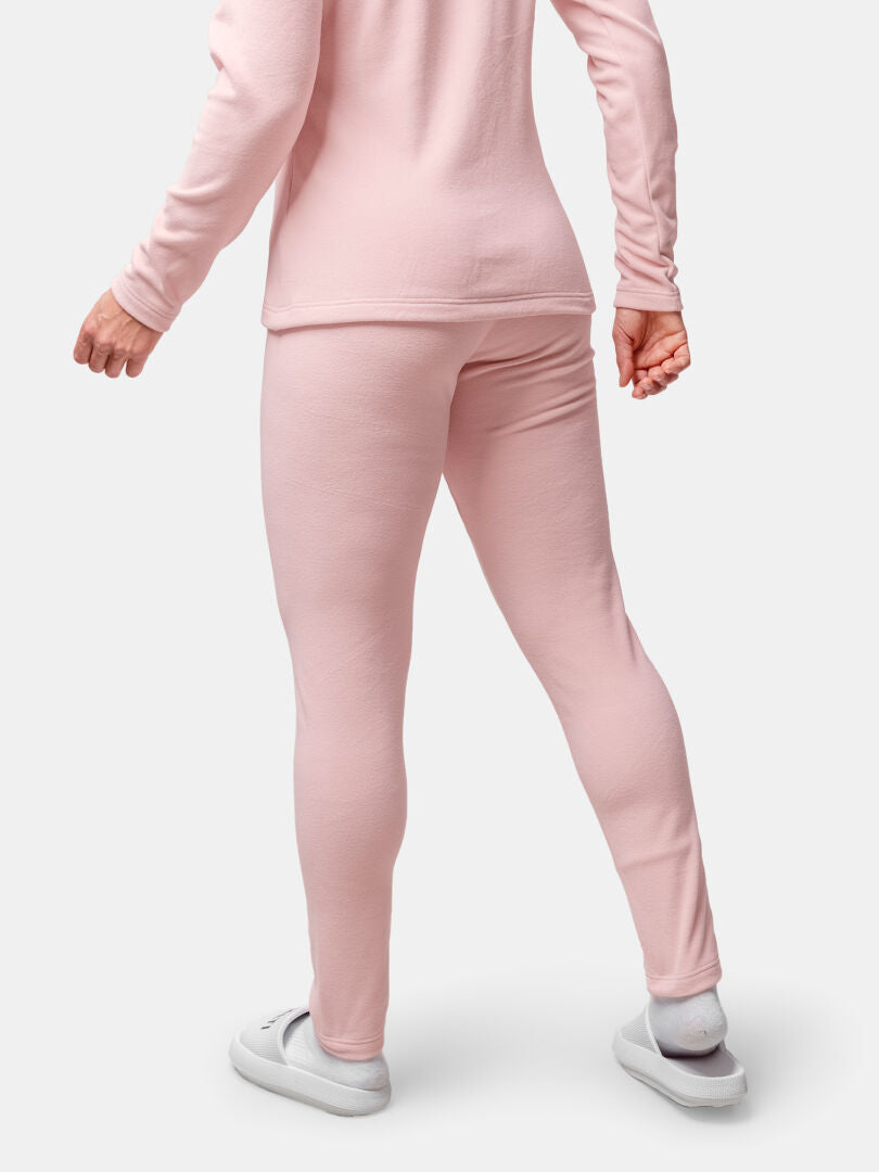 Woman shown from the back wearing Halti Trone Fleece Pants and a light pink long-sleeve top with white slippers.