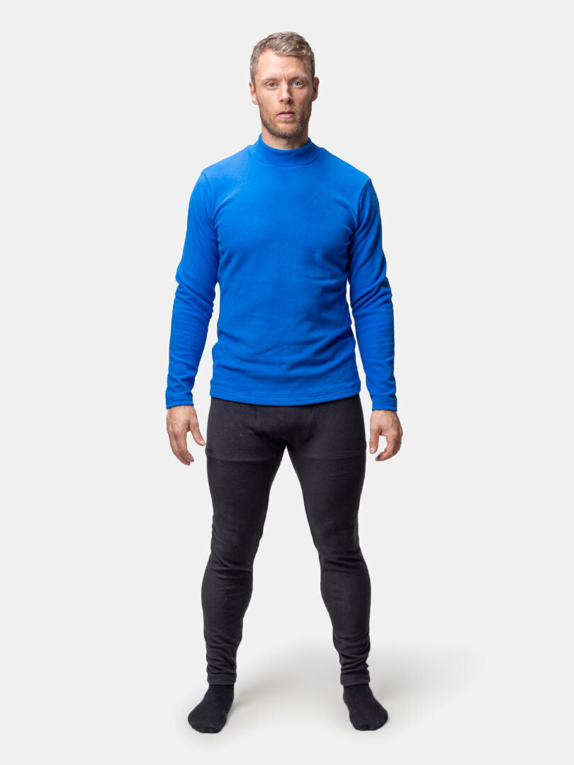 A man models the Halti Trone Fleece Shirt Mens in blue and black leggings, ready for activity against a plain background.