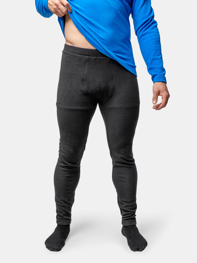 A person lifts their shirt to show the waistband of Halti Trone Fleece Pants Mens.