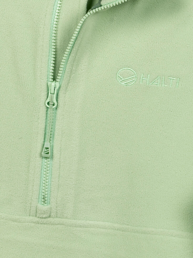 Close-up of Haltis Ossia Half Zip Fleece Shirt Womens in light green, ideal for outdoor adventures.