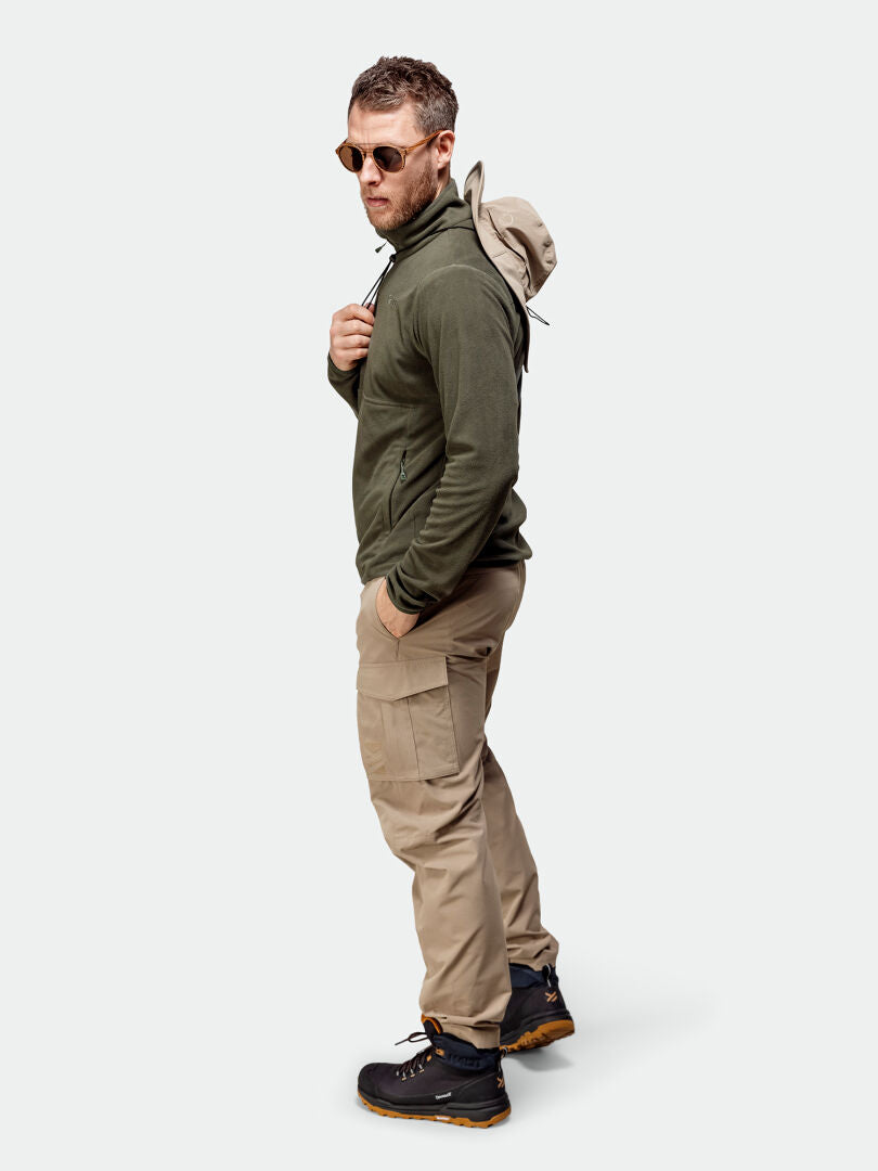 Man in sunglasses and khaki cargos wears the Halti Ossia Half Zip Fleece Shirt Men's as a cozy, lightweight layer.