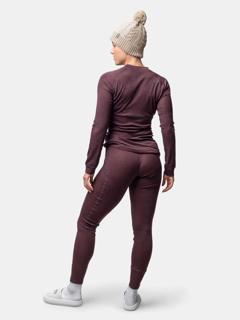 Person wears a beige knit beanie and Halti Hossa II Merino Base Layer Set Women's, standing and facing away.
