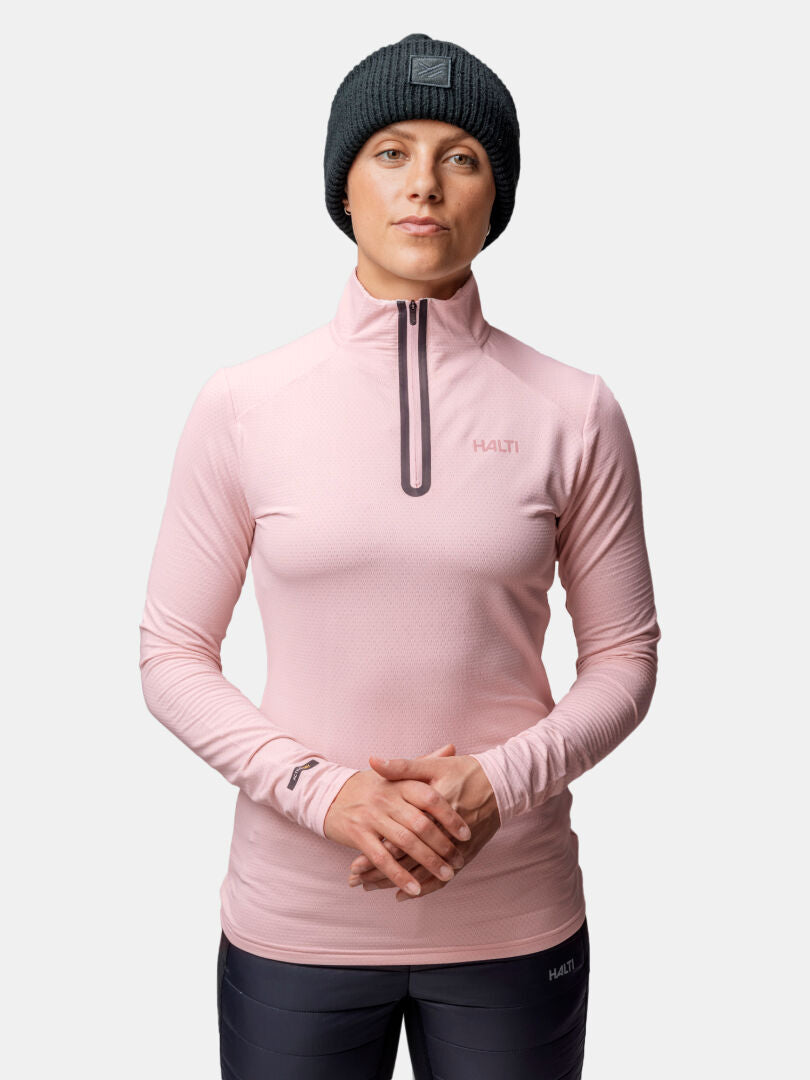 A person in a black beanie and Halti Jaako Shirt Women's stands against a plain light background.