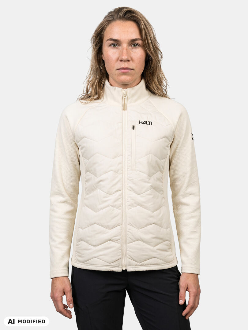 Woman in Halti Suomis Hybrid Layer Jacket, perfect for outdoors, poses against a light background.