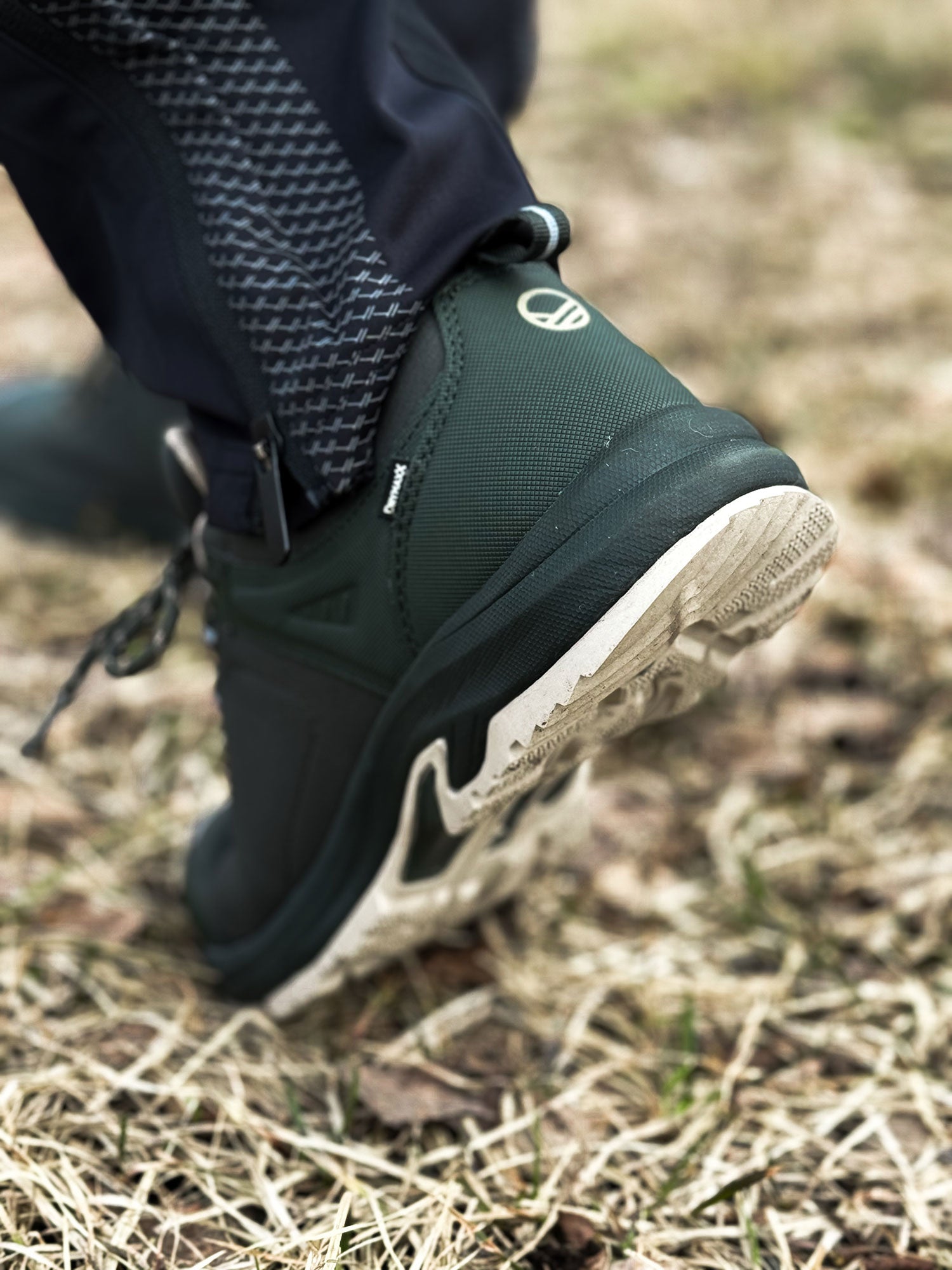 Wearing Halti's Outdoor Shoes Low DX Men's with GripmaxX Antislip soles, he walks on dry, patchy grass.