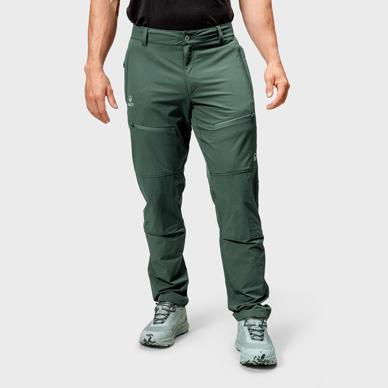 A man wears Halti Pallas III Warm X-stretch outdoor pants, standing against a plain light gray background.