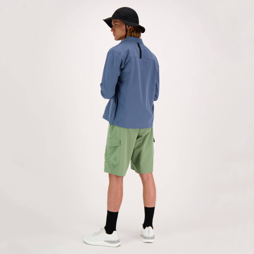 A person in a Halti Bluusi Unisex Shirt stands facing away, embodying timeless athleisure in breathable fabric.