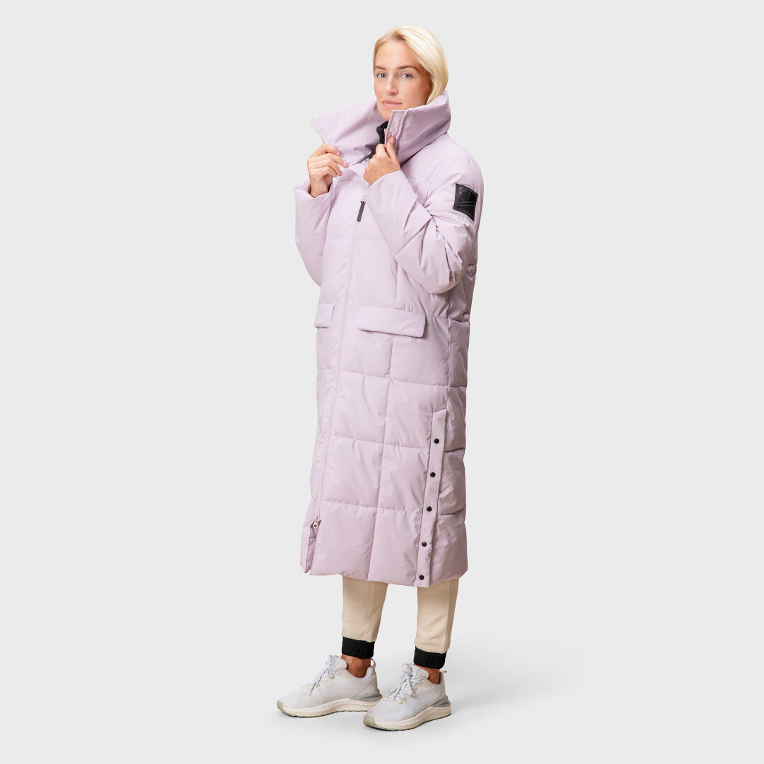 A person wears the Halti Penger Winter Jacket Womens in light purple with DrymaxX® fabric against a plain background.