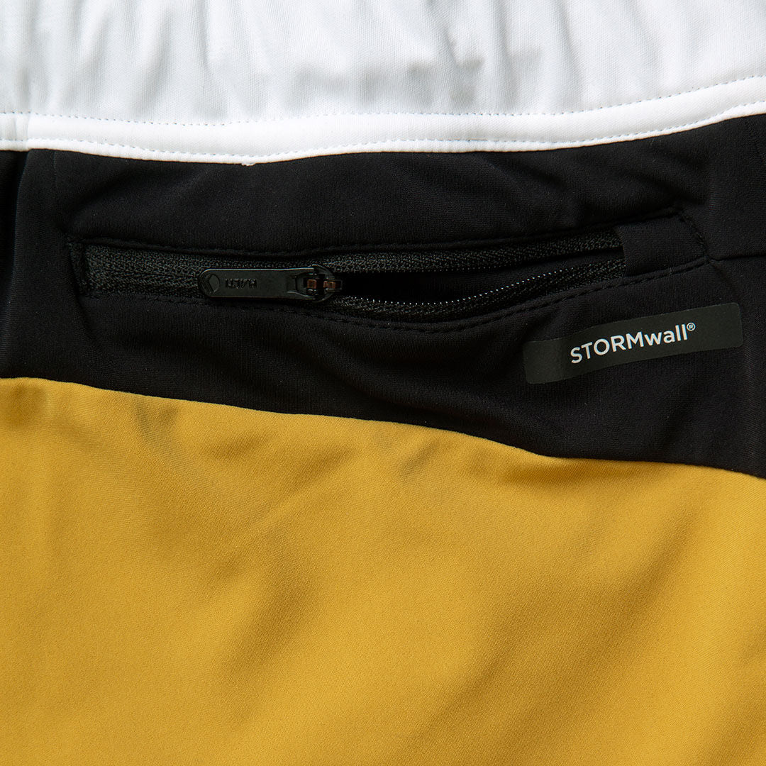 Close-up of a zippered pocket on Halti Veloce XCT Pants Womens with STORMwall® label and bold color blocking.
