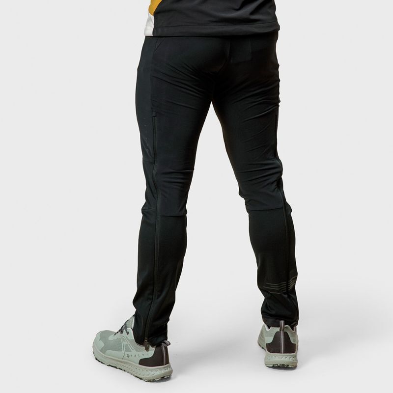 Person wearing Halti Veloce XCT Pants Mens and light gray sneakers, shown from the back on a plain white background.
