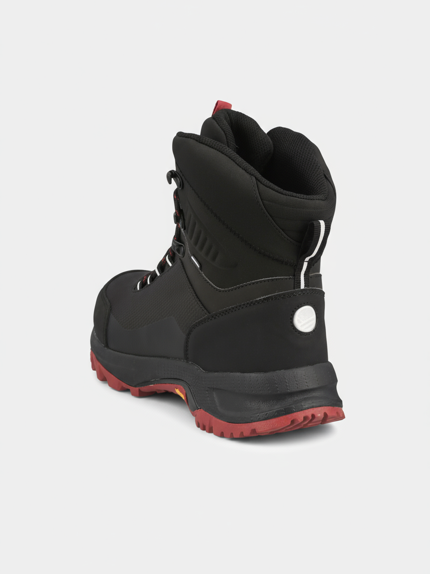 The Halti Rorvik Men's Mid DrymaxX Trekking Shoe features a black upper, red sole and laces, shown from the rear angle.