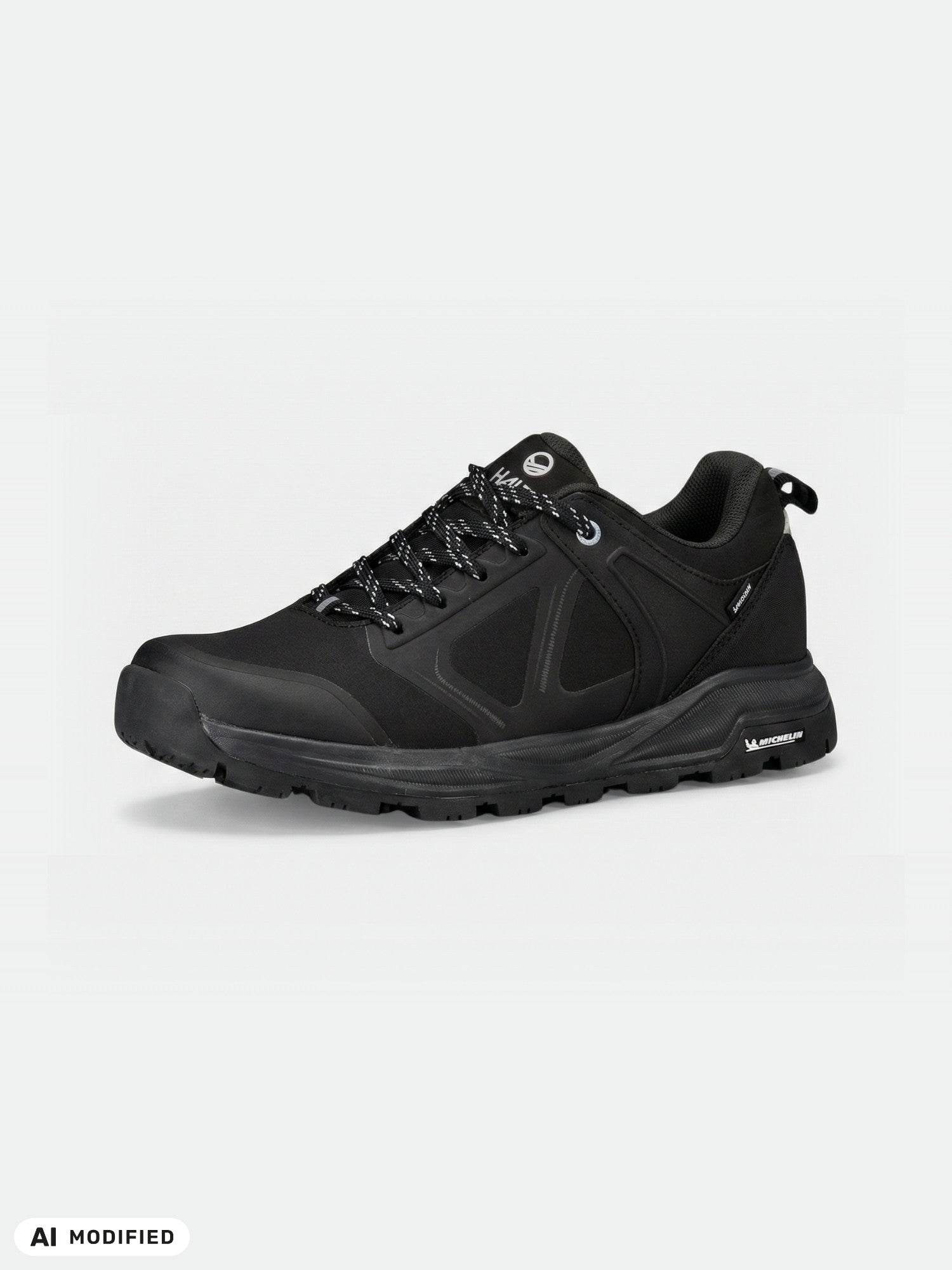 Halti Jura Low DX Grip women's shoe: black, lace-up, waterproof, Michelin Ice Control sole, subtle branding.