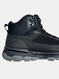 Halti Fara 3 DX Mid Outdoor Shoe for women in black/gray with textured sole and fabric upper, side view on white.