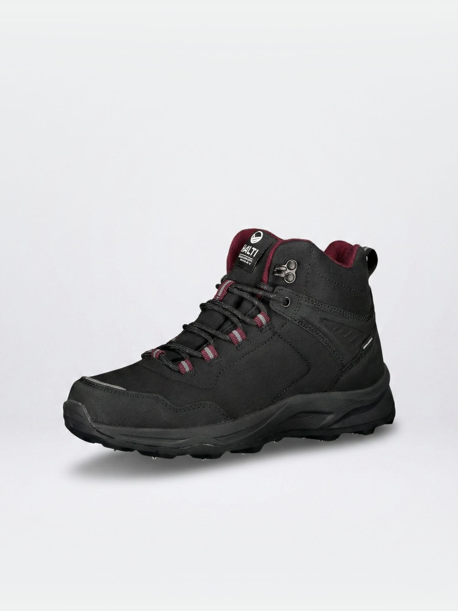 The Halti Lynx Mid 2 DX Spike Shoe Women's is a black, waterproof boot with maroon lining and a rugged GripmaxX Spike outsole.