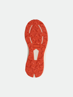 Orange rubber sole of Halti Rapid DX Mid Outdoor Shoe Womens, featuring star-shaped tread, shown from below.