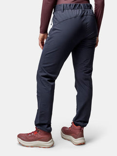 Person wears dark pants, maroon top, and Halti Rapid DX Mid Outdoor Shoe Womens, shown from the back on plain background.