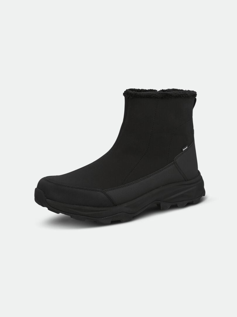 The Halti Nanook 3 DX Spike Shoe is a black winter ankle boot with spikes and a soft lining, shown on a light background.