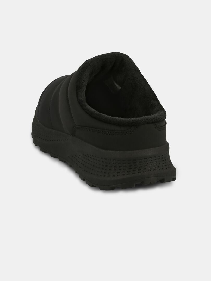 The Halti Rest 2 Slipper is black, slip-on, with a plush lining and textured sole, shown from the back on white.