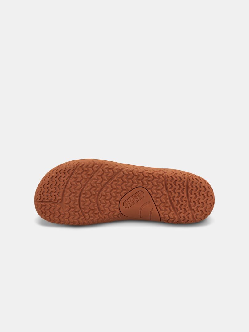 The Halti Tuntuma Barefoot Shoe's brown rubber sole features wavy tread and zero-drop, water-resistant design.