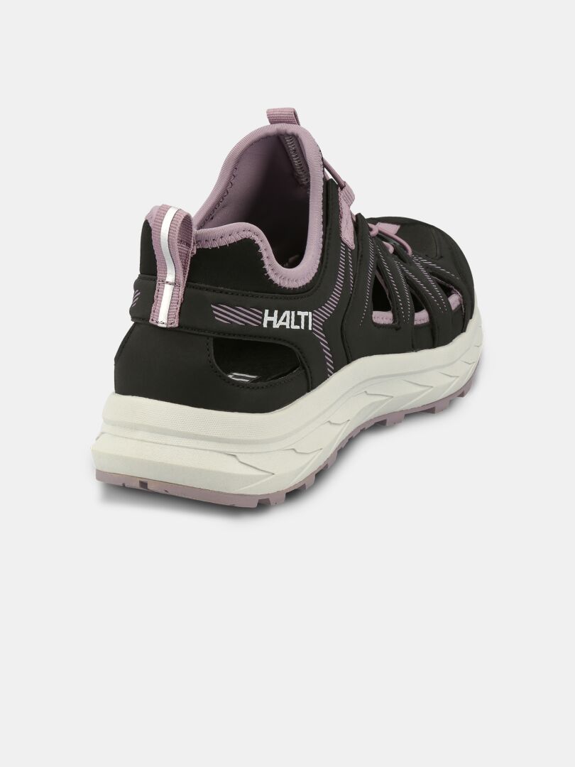 The Seili Hybrid Sandal Women's by Halti is a black and pink sandal-sneaker with a thick white sole, viewed from the back left.