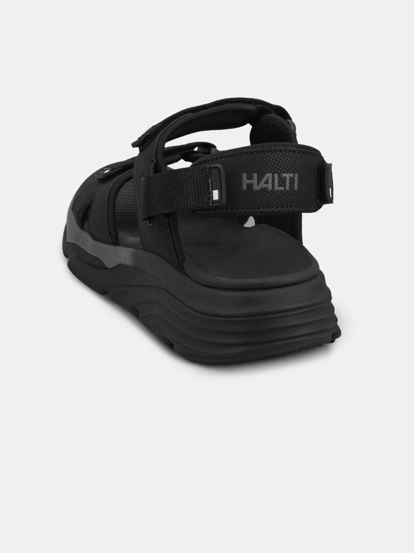 The Halti Pursuit 2 Sport Sandal is a black, lightweight sandal with cushioned sole, shown from the rear angle.