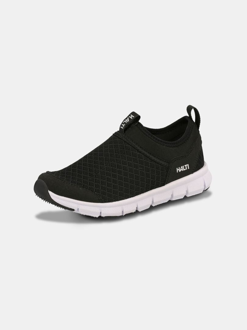 The Halti Lente 3 Leisure Shoe for kids is a black slip-on with mesh upper, white sole, and brand label accents.