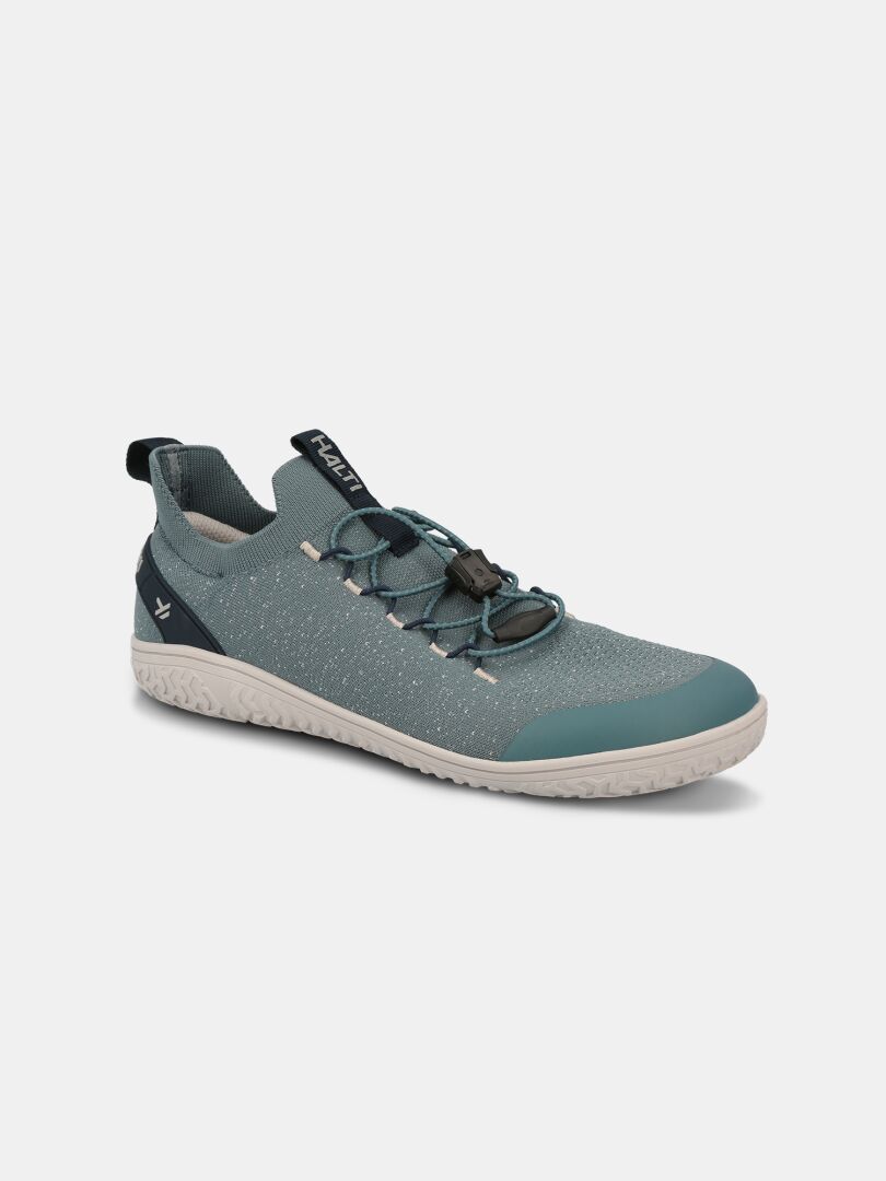 The Halti Vire Barefoot Shoe Men's is a teal and grey zero-drop sneaker with toggle laces and a white sole.