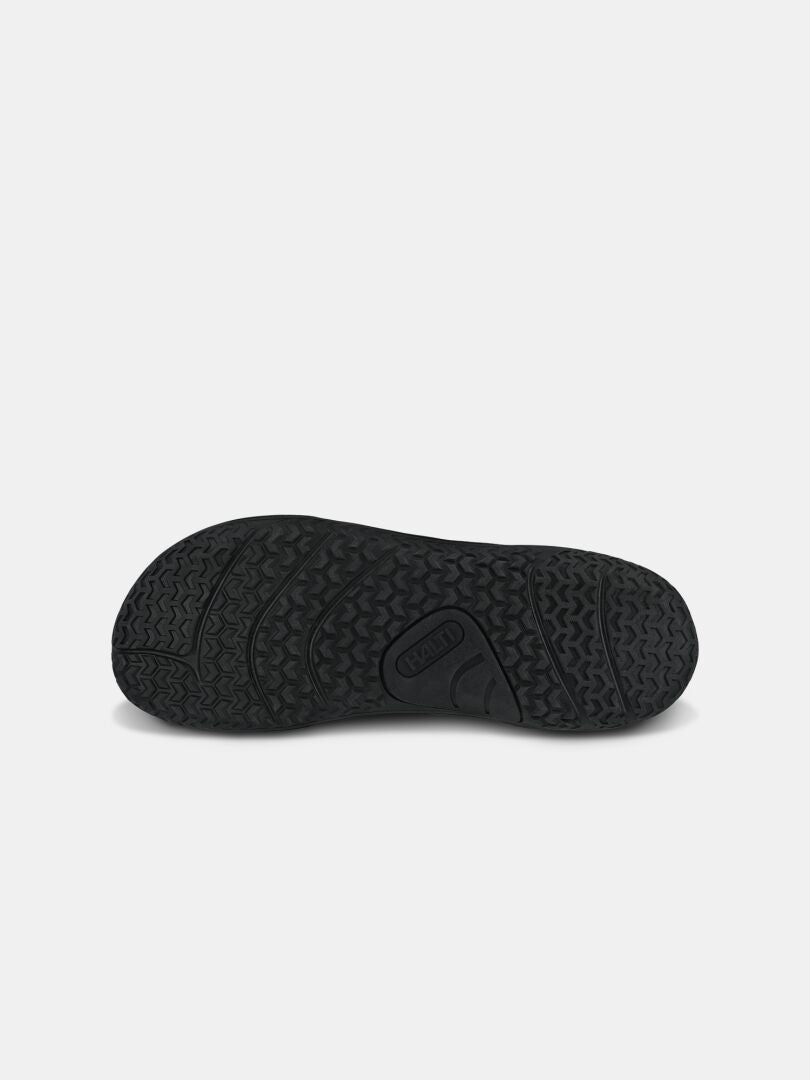 Black rubber sole with textured tread; Halti Tuntuma Mid DX Barefoot Shoe Men’s logo embossed at center, plain background.