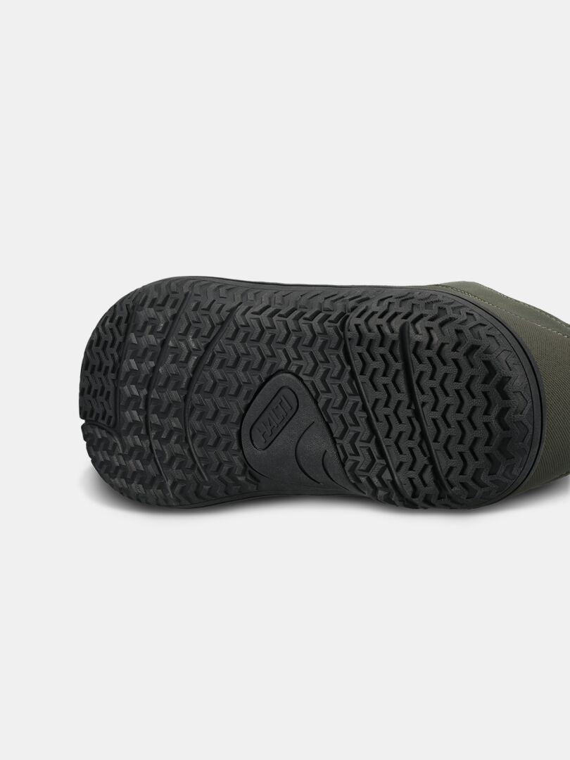 Close-up of the Halti Tuntuma DX Barefoot Shoe Men's black zero drop sole, showing tread and green upper.