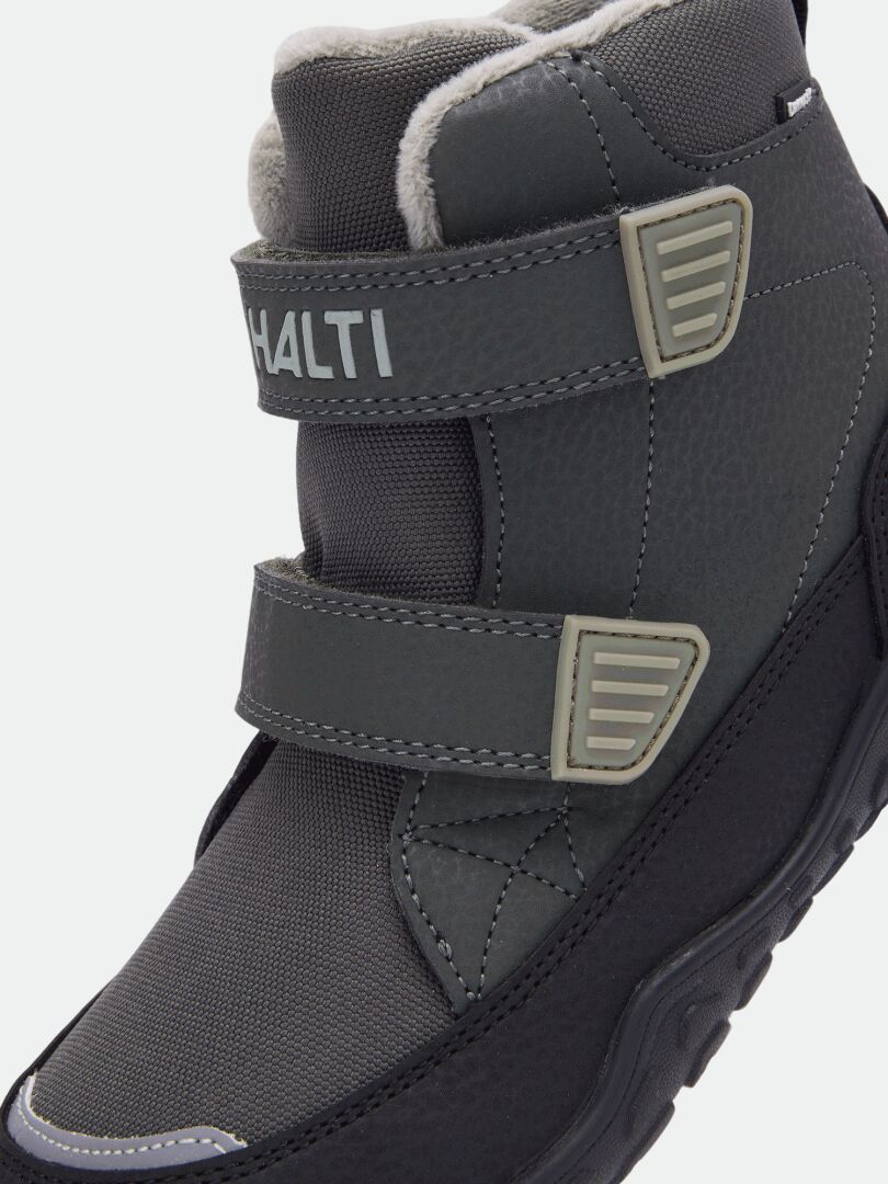 Close-up of Halti Jalava DX kids’ dark gray barefoot ankle boot with two hook-and-loop straps and black textured sole.