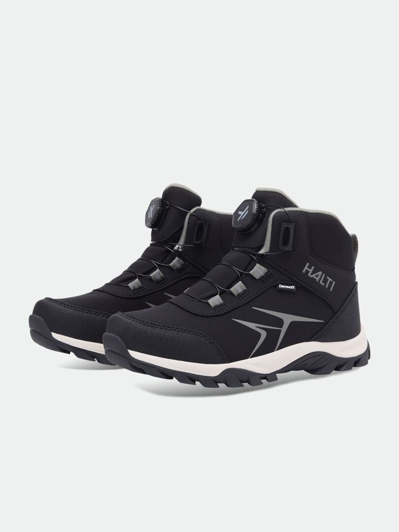Black mid-top lightweight Halti Tribe Dada DX Outdoor Shoe children’s shoe with a dial-lacing system and white lugged sole.