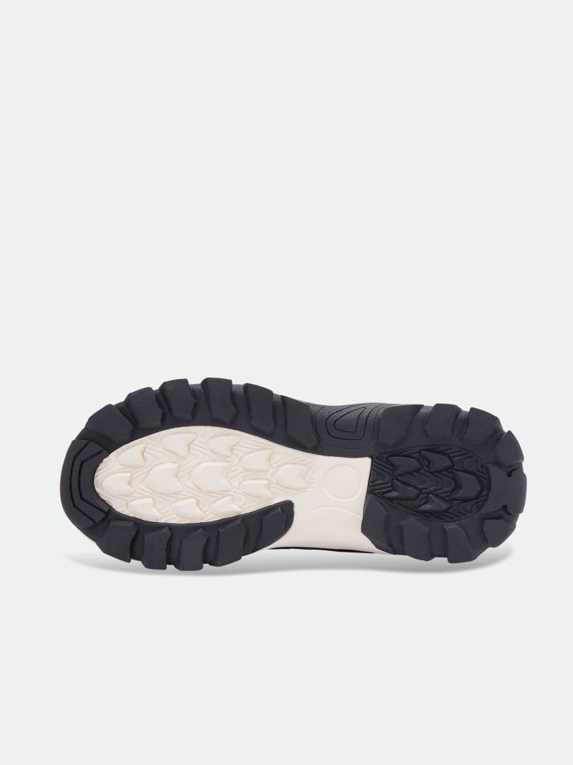 Black and white lugged rubber outsole of a lightweight Tribe Dada DX Outdoor Shoe children’s shoe.