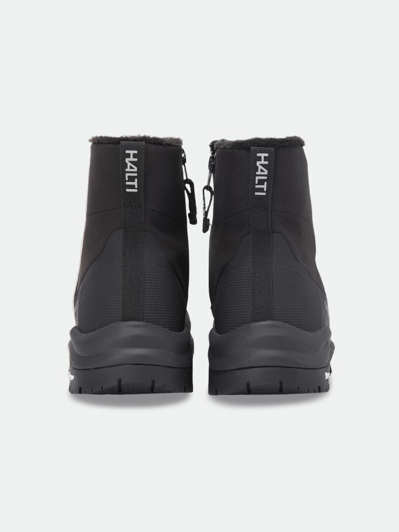 Back view of two black Kajuk Mid DX IC Winter Shoe mid-tops with side zippers, faux-fur lining, and Michelin outsoles.