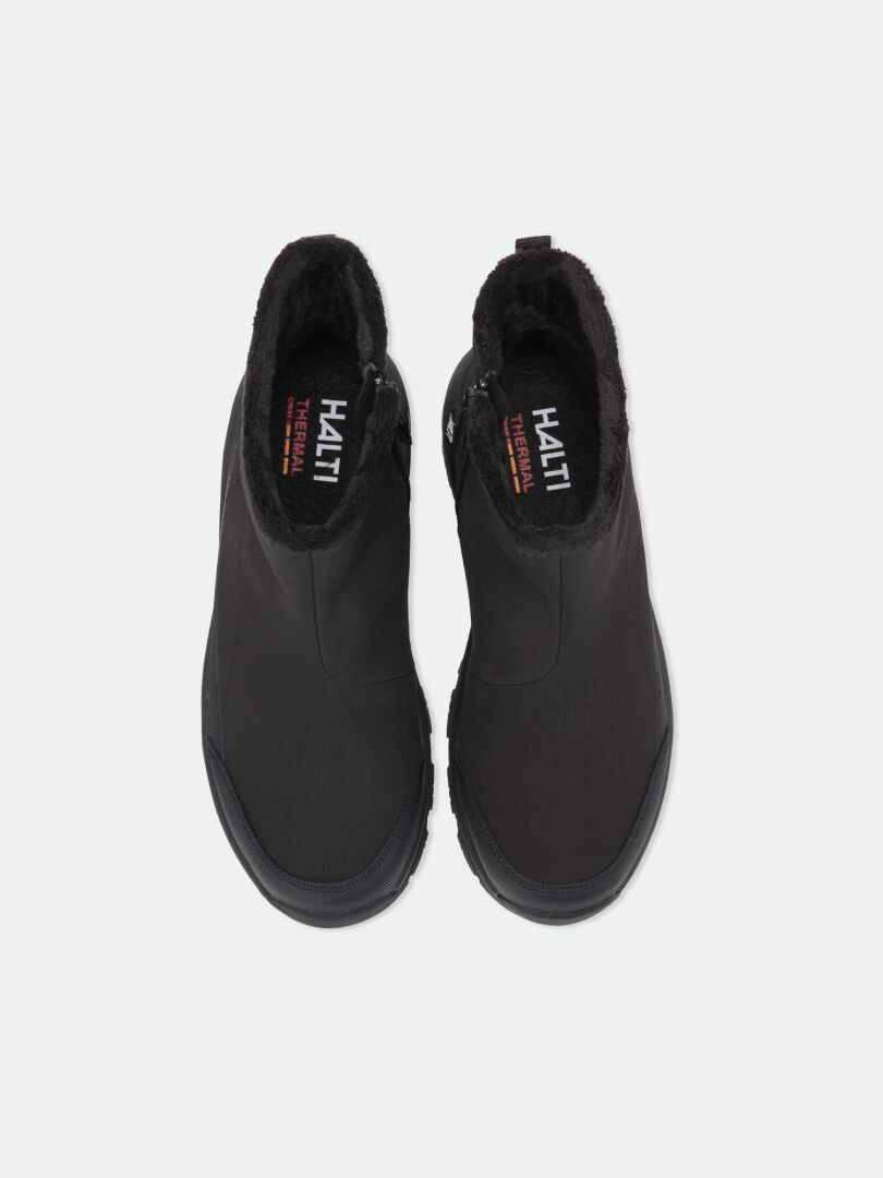 Top-down view of black, waterproof Kajuk Mid DX IC winter boots with Michelin Ice Grip outsoles and fur-lined collars.