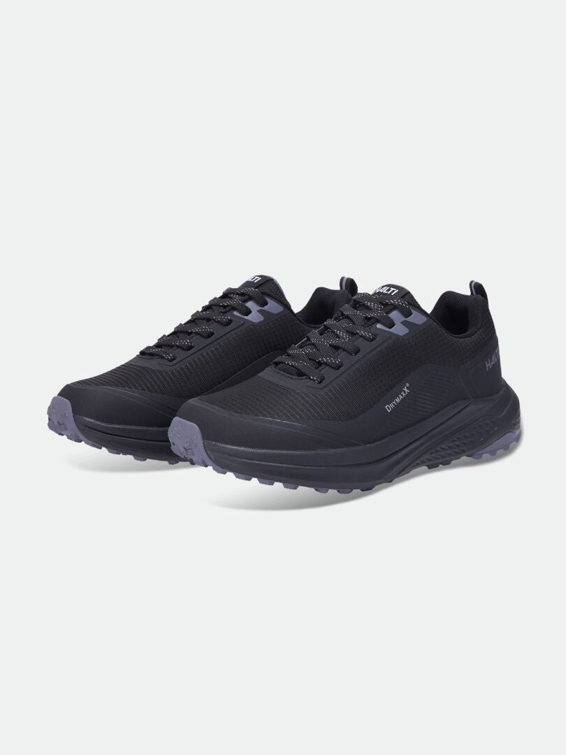 Halti Asento DX Women’s: Black athletic sneakers with gray soles, side branding, and barefoot-inspired design.