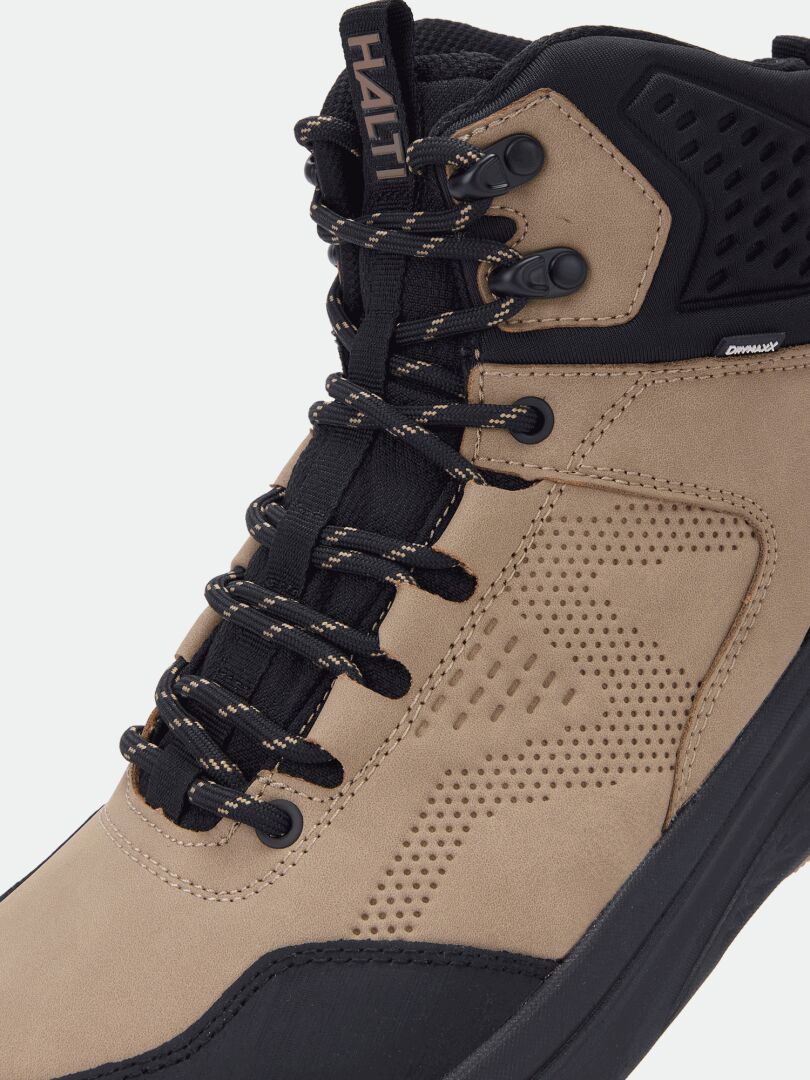 Close-up of the Halti Asento Mid DX men’s tan hiking shoe with black laces, metal eyelets, and padded tongue.