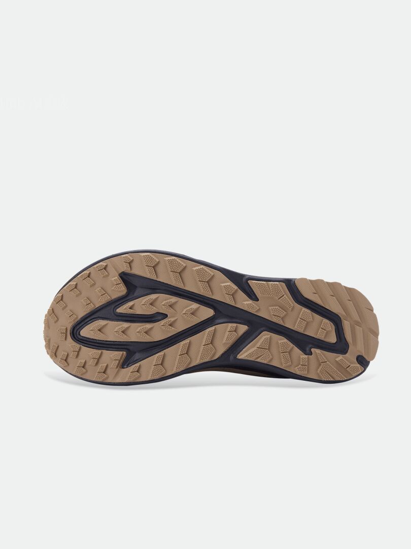 Brown and black rubber sole of Halti Asento Mid DX Men’s zero-drop shoe, viewed from below against a white background.