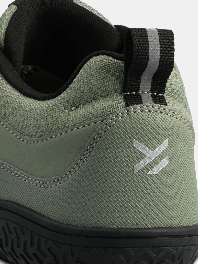 Close-up of the heel on Halti Tuntuma DX Barefoot Shoe Women's—a green waterproof sneaker with black pull tab, logo.