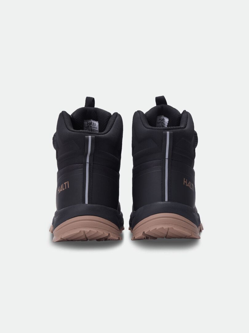 Pair of black Halti Fara Mid 3 DX Freelock shoes with tan trail rubber soles, shown from the back on white background.