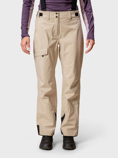 Person wearing Halti Settler 3L DrymaxX Womens ski pants, black suspenders, black boots, and a purple long-sleeve shirt.