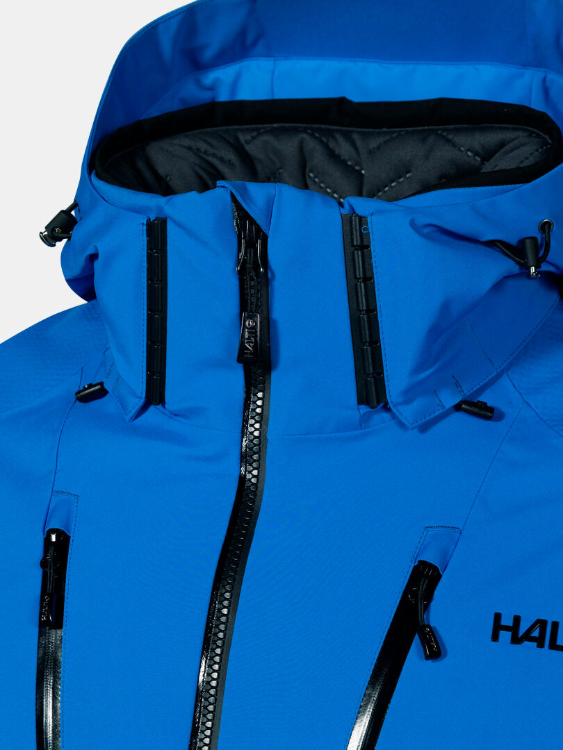 Close-up of the Halti Vertica DX Ski Jacket Men's: blue, high collar, black zippers, drawstrings, waterproof fabric.