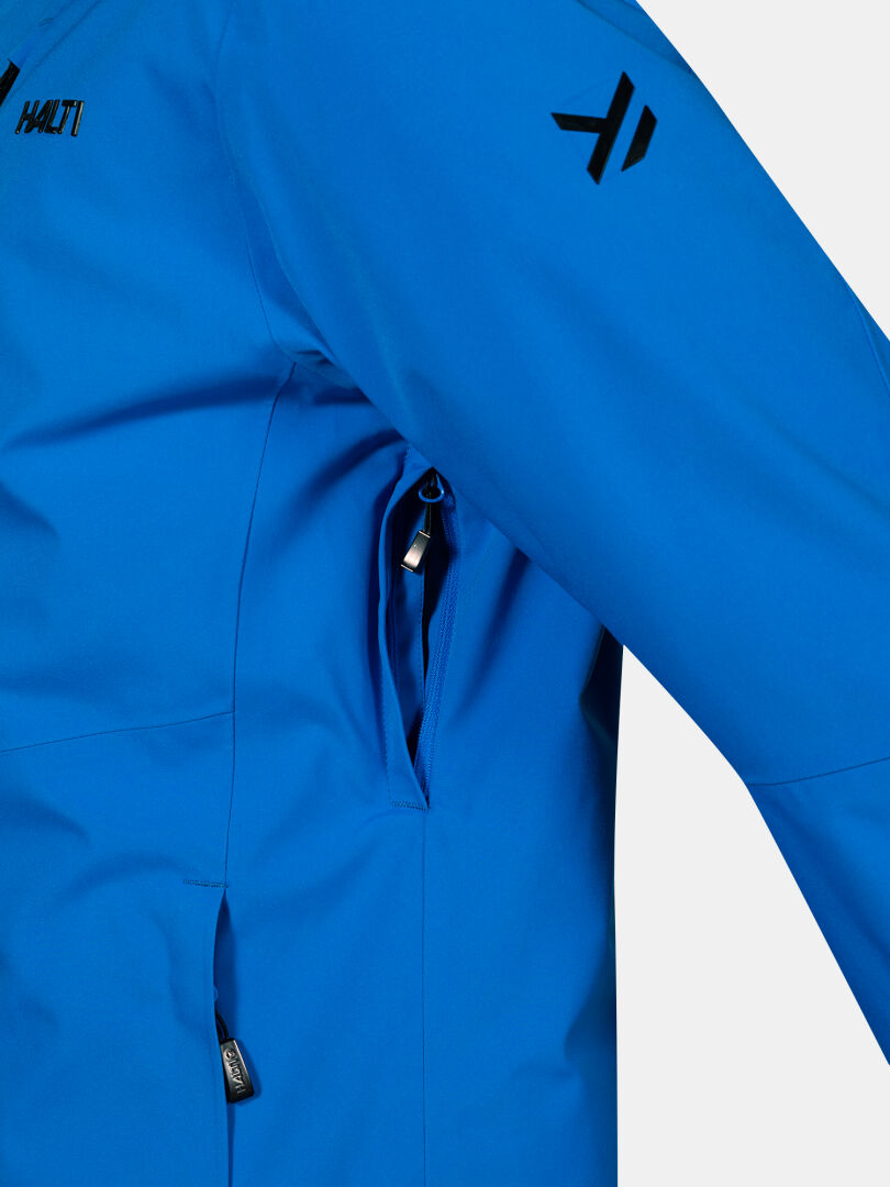 Close-up of a blue Halti Vertica DX Ski Jacket Men’s showing a zippered underarm vent and a chest pocket.