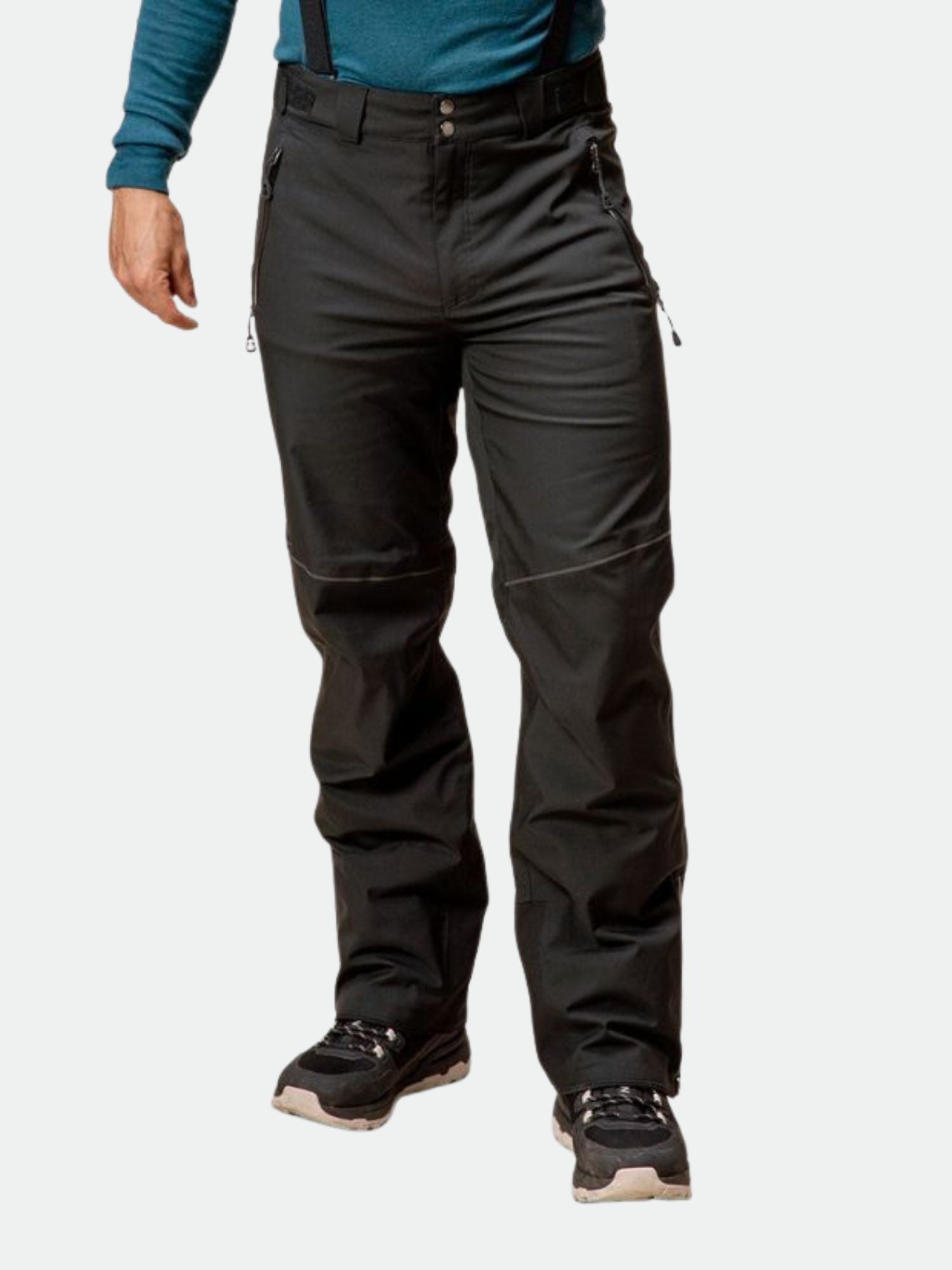 A person wears Halti Vertica DrymaxX men's ski pants, black shoes, and a teal long-sleeve shirt.