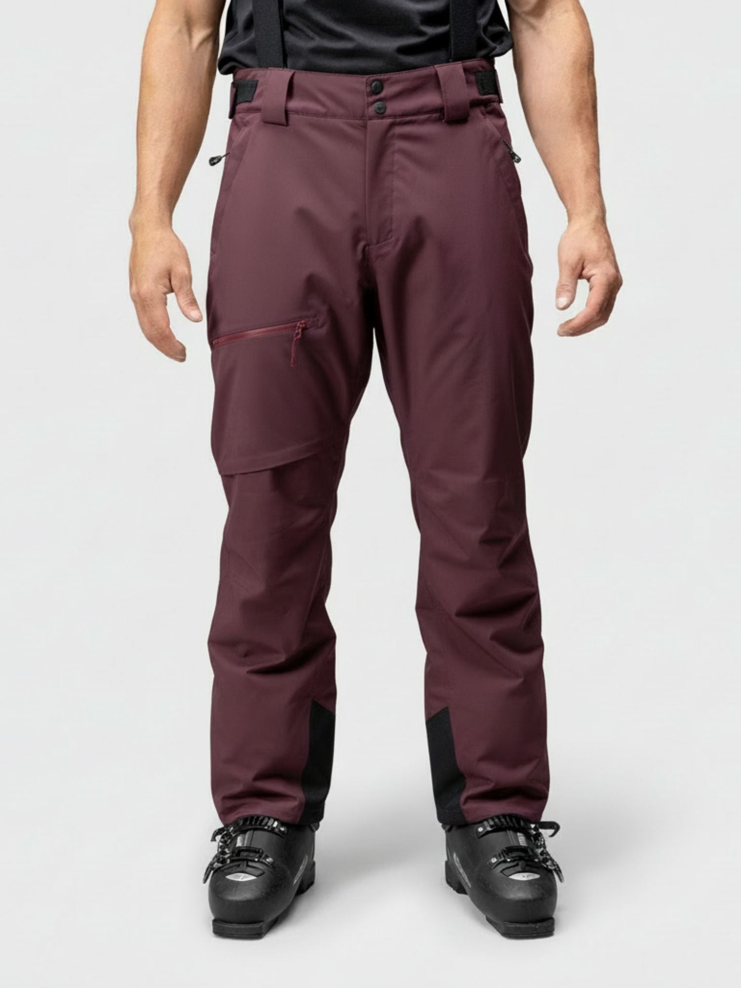 A man wears Halti Carvey DrymaxX Ski Pants in maroon with black ski boots, shown from the front on a plain background.