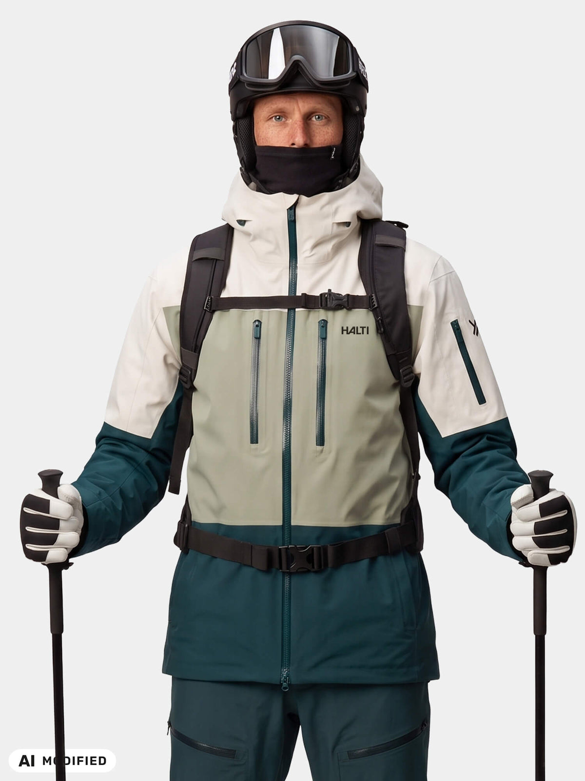 A skier in a Halti Rizle Unisex 3L DX Ski Jacket, helmet, goggles, and backpack holds ski poles.